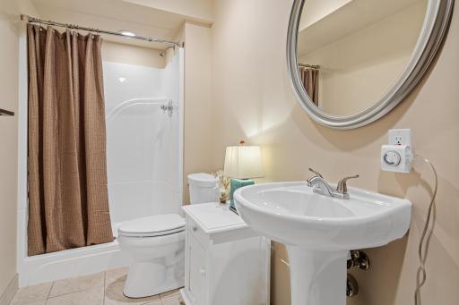 A convenient lower-level 3/4 bathroom adds functionality to the finished lower level. Its location is ideal for family, guests, or easy access from the recreation spaces.