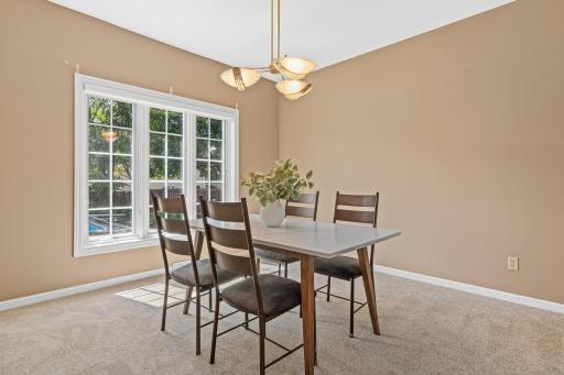 The inviting dining room provides the perfect setting for everyday meals or hosting family and friends. Its comfortable layout flows seamlessly with the main living spaces for effortless entertaining.