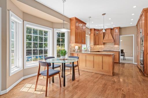 The centrally located informal dining area offers a welcoming space for casual meals and everyday gatherings, with easy access to the deck and beautiful backyard.