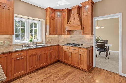 Abundant counter space and bright lighting provide an inviting and functional space for cooking, gathering, and entertaining. Great views to your resort-like backyard.