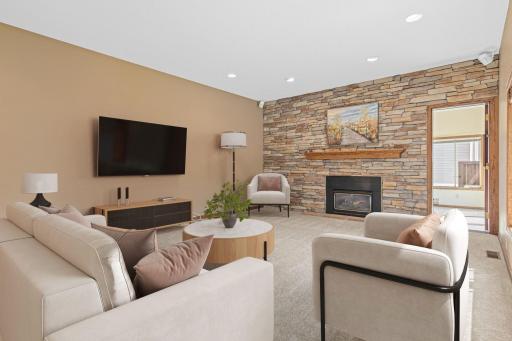 Warm, comfortable, and spacious, this versatile room offers the perfect place to unwind by the fire, enjoy movie nights, or gather for entertaining. Sunroom/porch just beyond. Virtually staged.