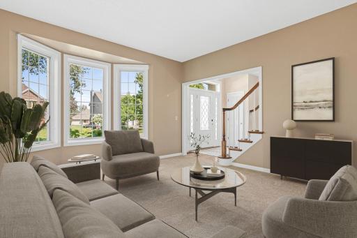 The spacious living room offers a comfortable setting for everyday living and entertaining. Abundant natural light and fresh 2026 carpet create a bright, welcoming atmosphere. Virtually staged.