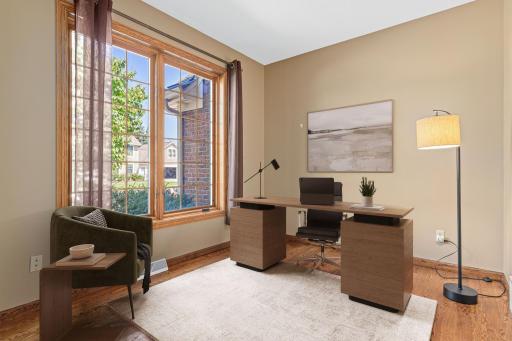 A main-floor office provides the perfect space for working from home, studying, or managing daily tasks. The versatile room offers privacy and functionality while blending beautifully with the home's main-level living spaces. Virtually staged.