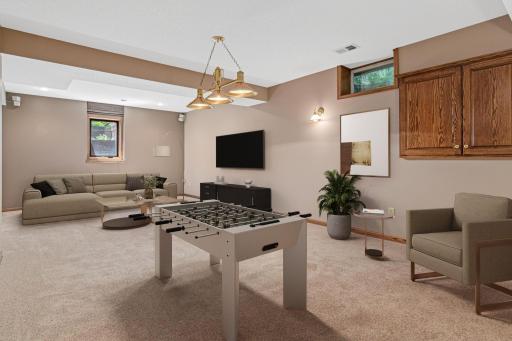 The finished lower level expands the home's living space with a versatile area perfect for recreation, movie nights, hobbies, or entertaining. There's plenty of room to customize the space to fit your lifestyle. Virtually staged.