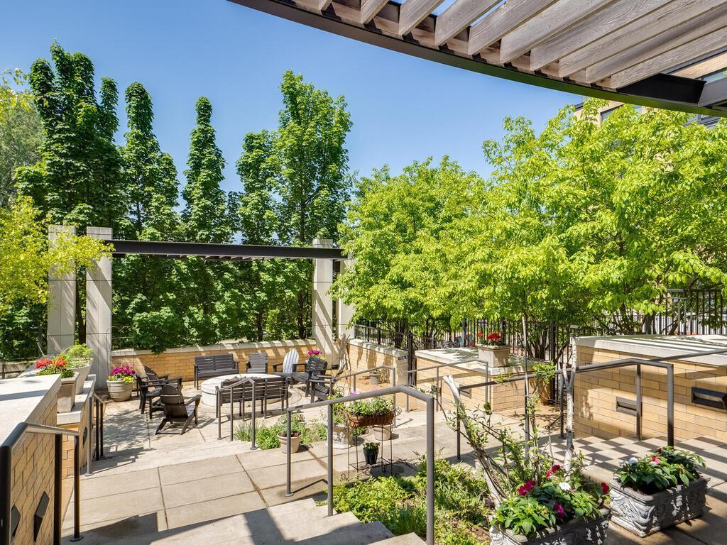 The Grand’s lush courtyard, complete with a fire pit, gas grills, pool, and hot tub, offers a picturesque backdrop to Wolfe Park.