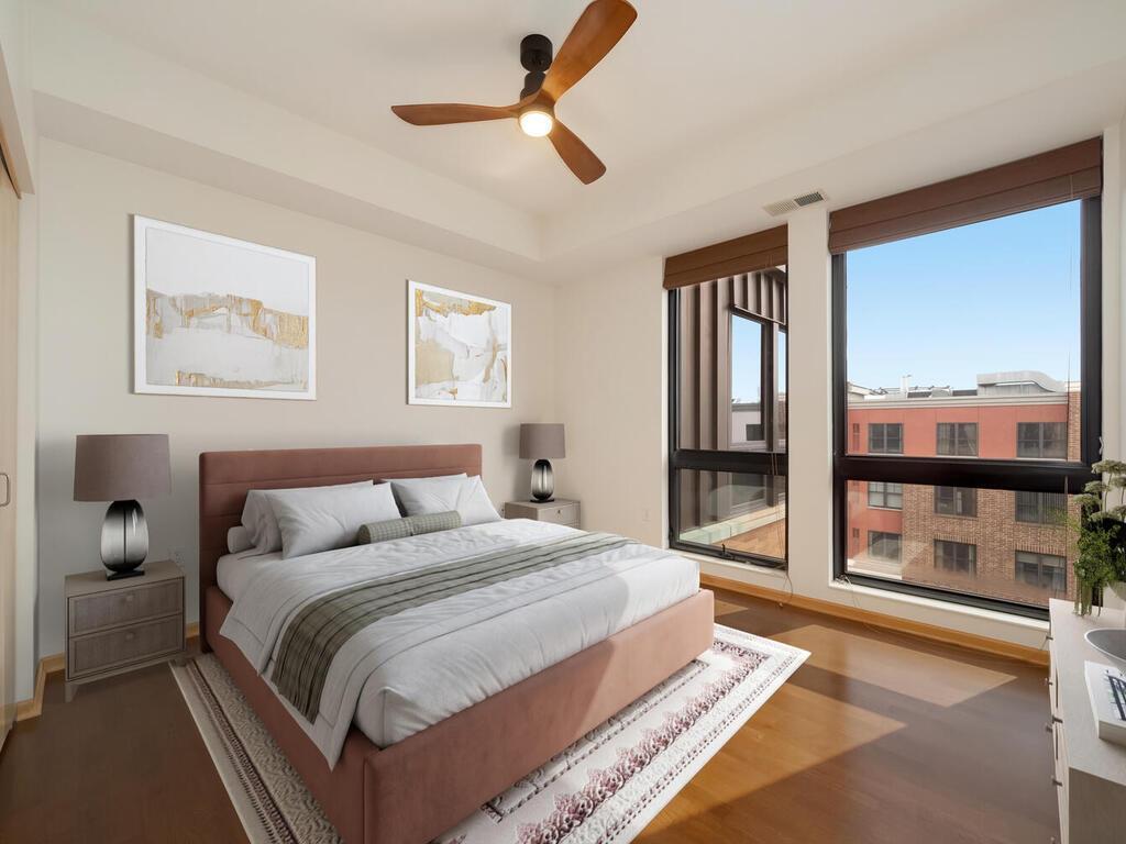 The second bedroom is highlighted with its floor-to-ceiling windows.