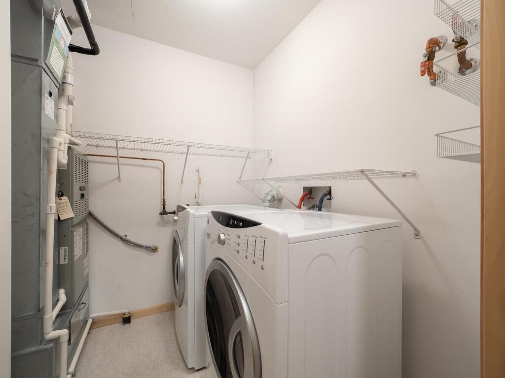 Enjoy your laundry room with its full-sized washer and dryer and added storage