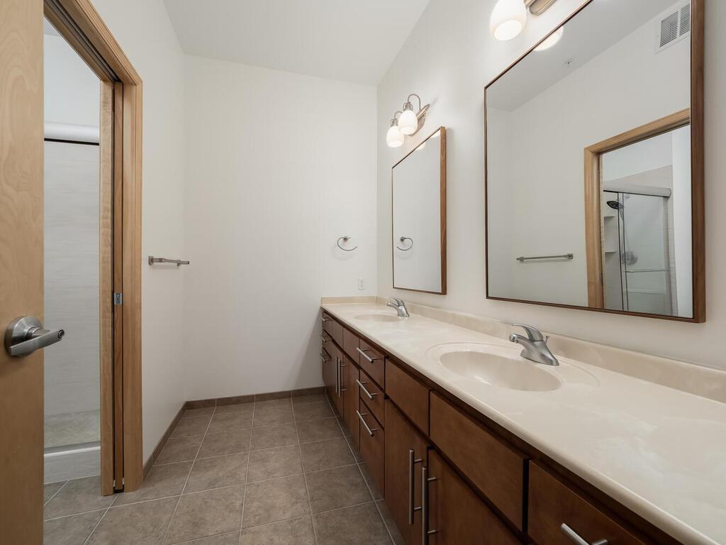 The primary bathroom ensuite features dual sinks and a separate wet room.