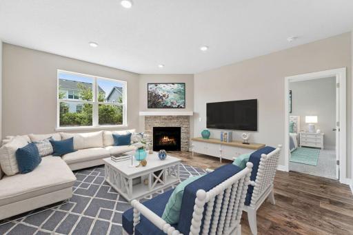 Separate living room space with the corner gas fireplace makes for a cozy feeling home. Model photo. Options and colors will vary in our available inventory homes.