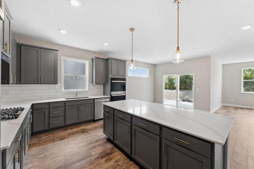 Modern design inspired color packages uniquely combine accent cabinet hardware with tile backsplash and quartz countertops. *Picture is of model home; actual finishes may vary.