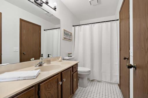 Bathroom with a walk-through layout, conveniently accessible from the main floor and upper-level bedrooms.