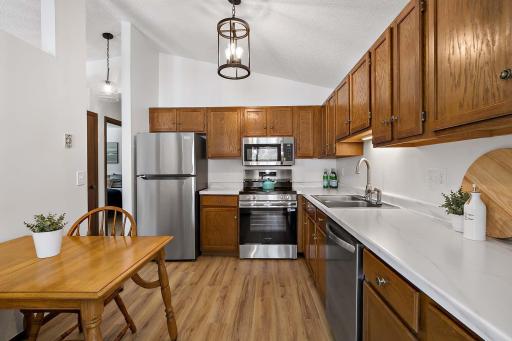 Recently updated kitchen with all-new stainless steel appliances, LVP flooring, modern lighting, and upgraded countertops.