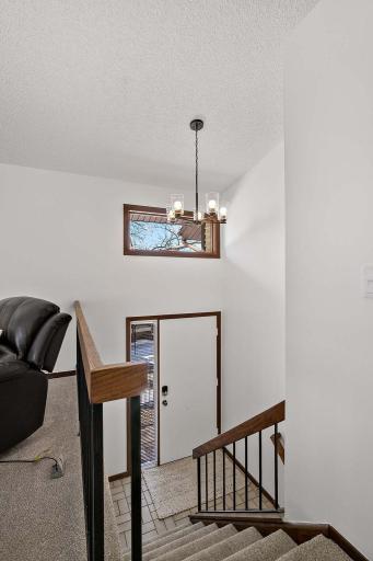Bright entryway filled with natural light and highlighted by vaulted ceilings, creating an open and welcoming first impression.