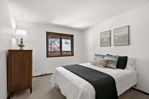 1 of 2 generously sized bedrooms on the upper level, offering comfort and ample space.