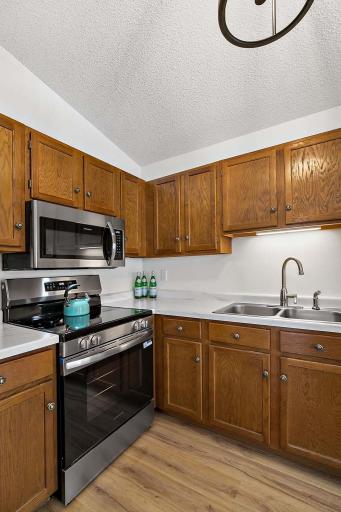 Recently updated kitchen with all-new stainless steel appliances, LVP flooring, modern lighting, and upgraded countertops.