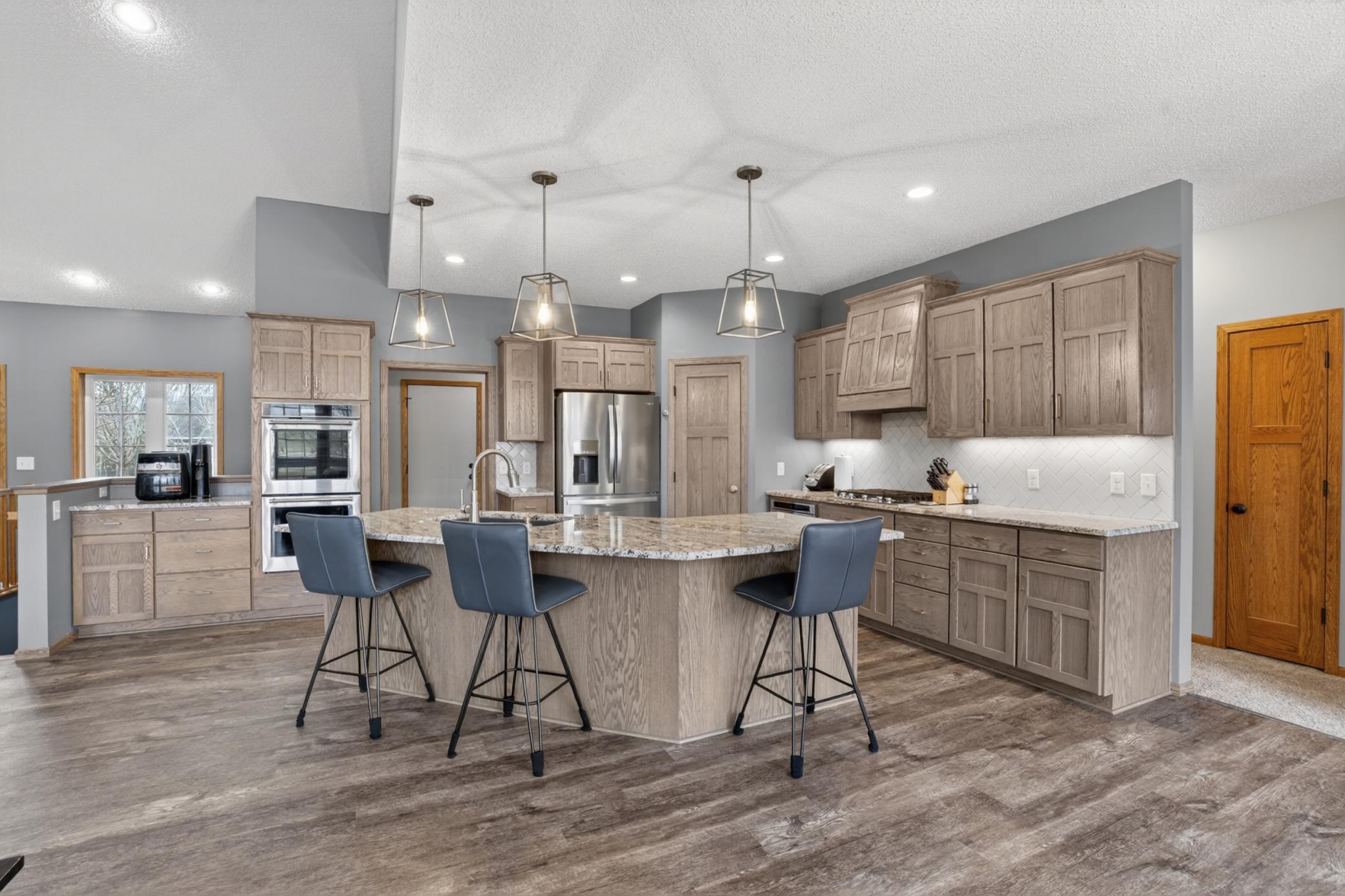 Custom designed and updated kitchen with double oven and coffee bar area.