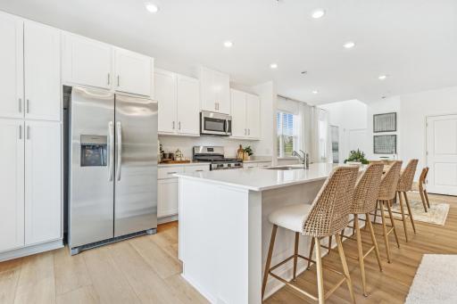(Photo of model home, features will vary) This center island includes a stainless steel sink with designer faucet to remove stubborn stains