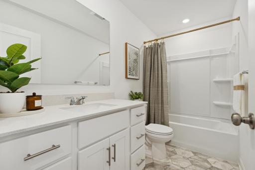 (Photo of model home, features will vary) A full-sized bathroom on the second floor comes well-equipped with a generously sized quartz-topped vanity and a combination shower and tub to maximize the interior space.