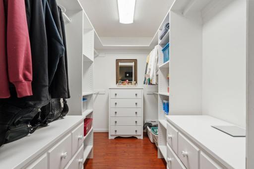 Primary walk-in closet with built in shelving