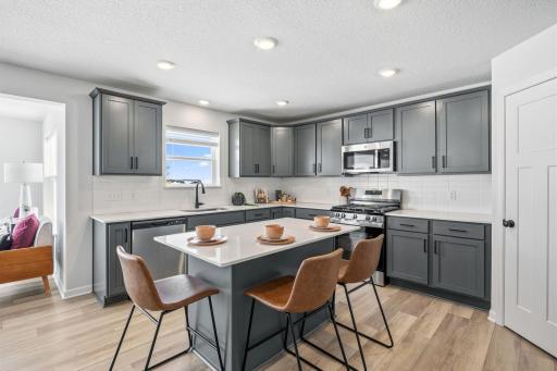 Kingston floorplan kitchen boasts plenty of cabinet storage and a corner pantry.