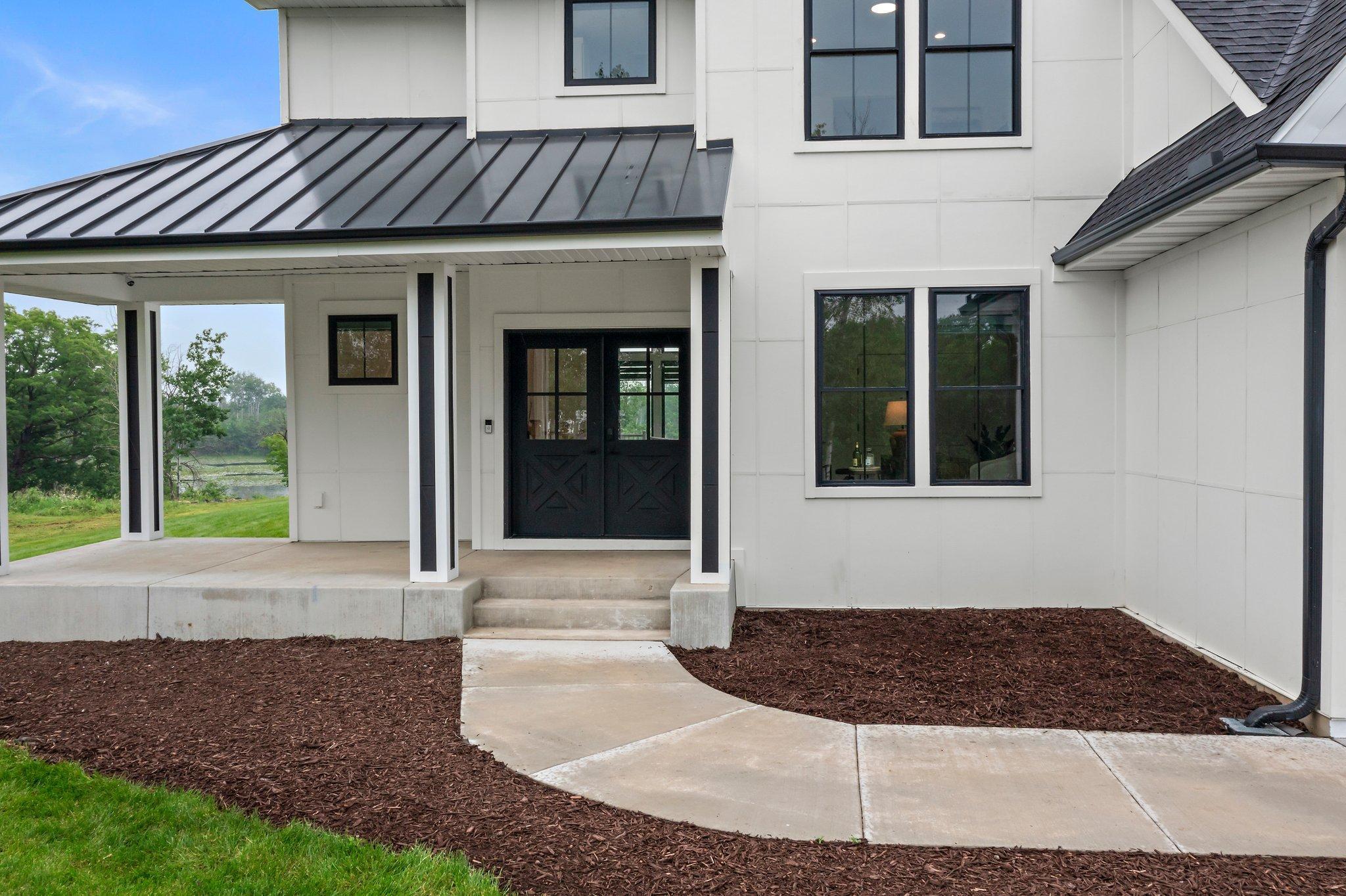 The inviting front porch is perfect for enjoying a morning coffee or evening relaxation and creates a welcoming ambiance.