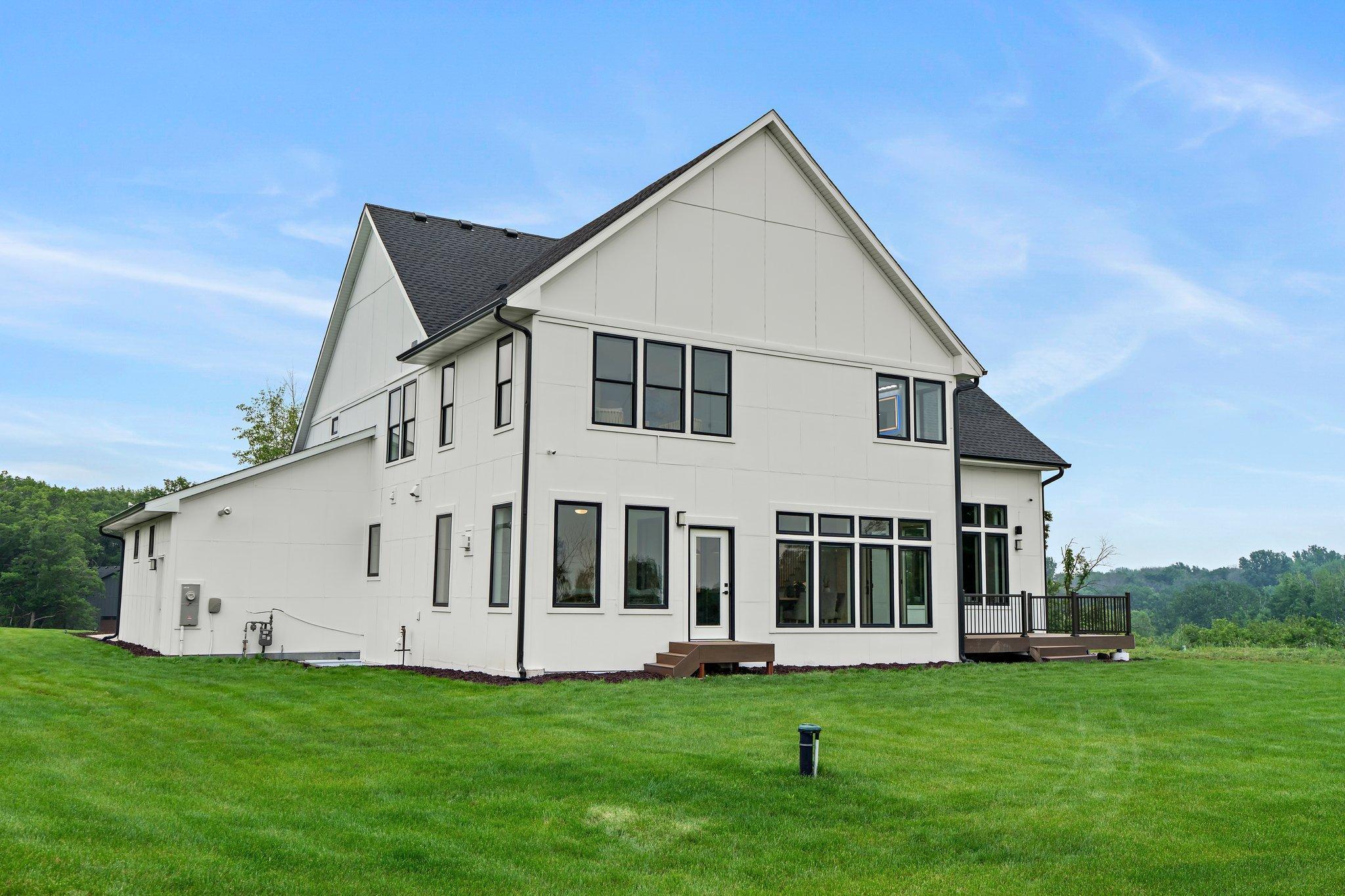 The flat backyard is a versatile outdoor space that overlooks a serene pond and is ideal for various activities and gatherings.