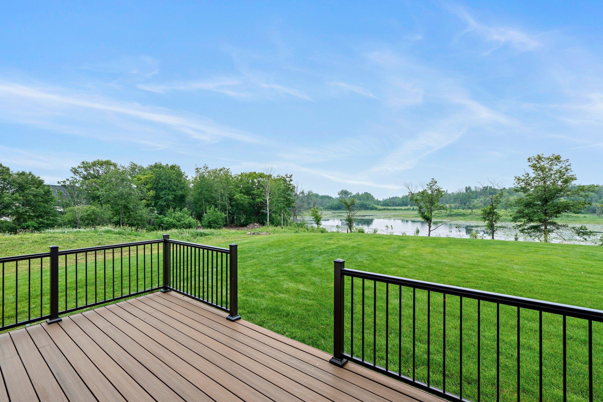 Step out from the dining room onto a spacious, maintenance-free deck—perfect for relaxing or entertaining while enjoying serene outdoor views.