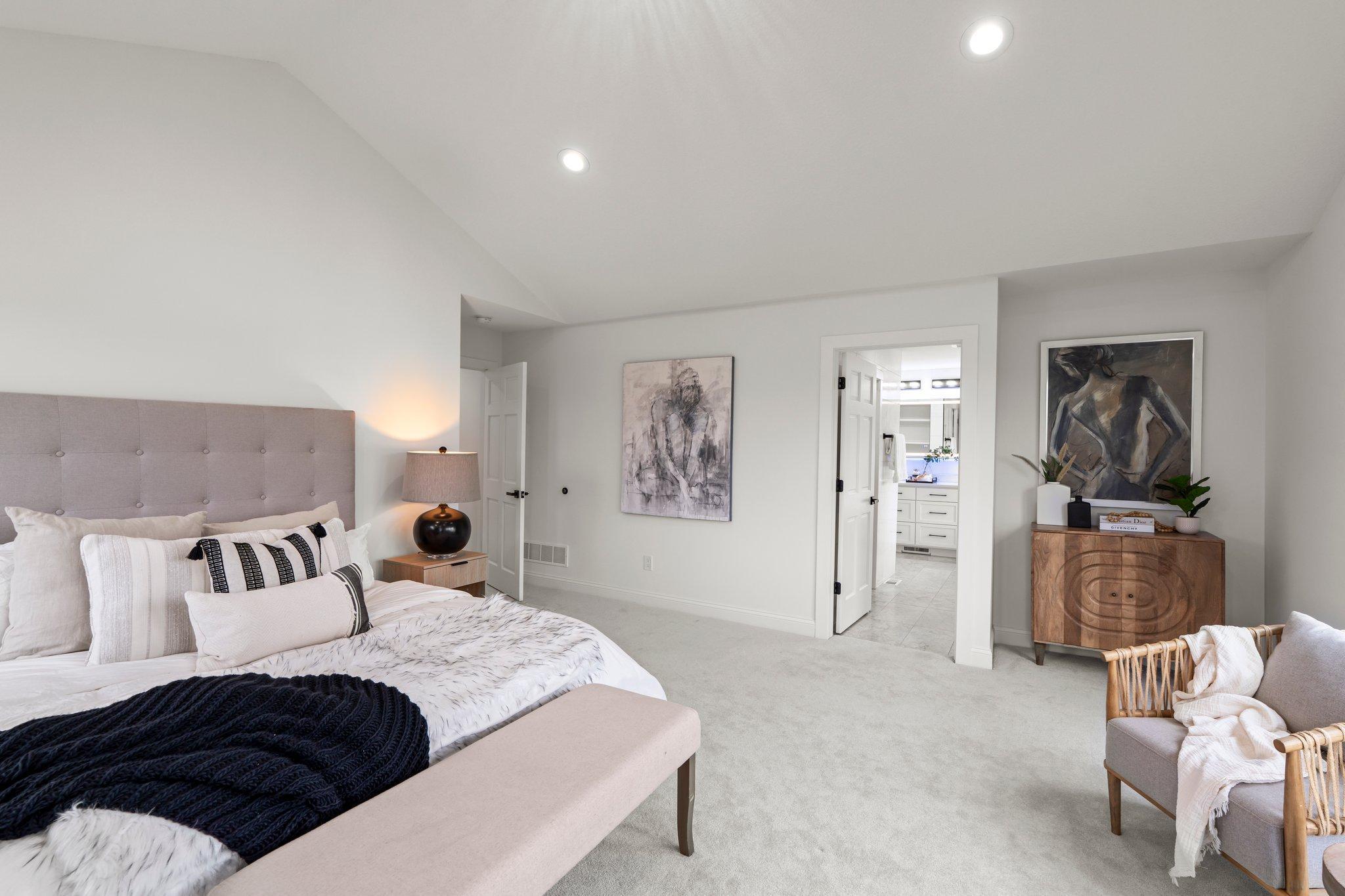 The primary bedroom is a serene retreat with impressive 11-foot vaulted ceilings that enhance the sense of space.