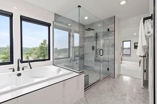 The primary ensuite boasts a luxurious, spacious walk-in shower beautifully finished with elegant tilework for a spa-like retreat.