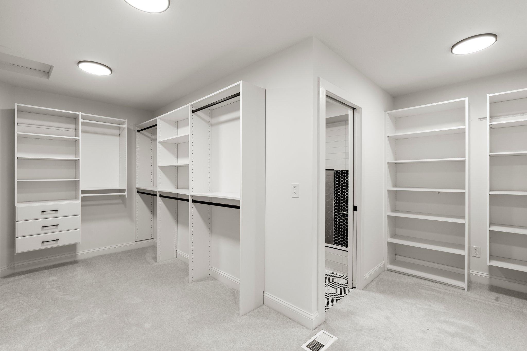 The primary bedroom also has a generously sized walk-in closet with custom built-ins, ensuring ample storage and organization.