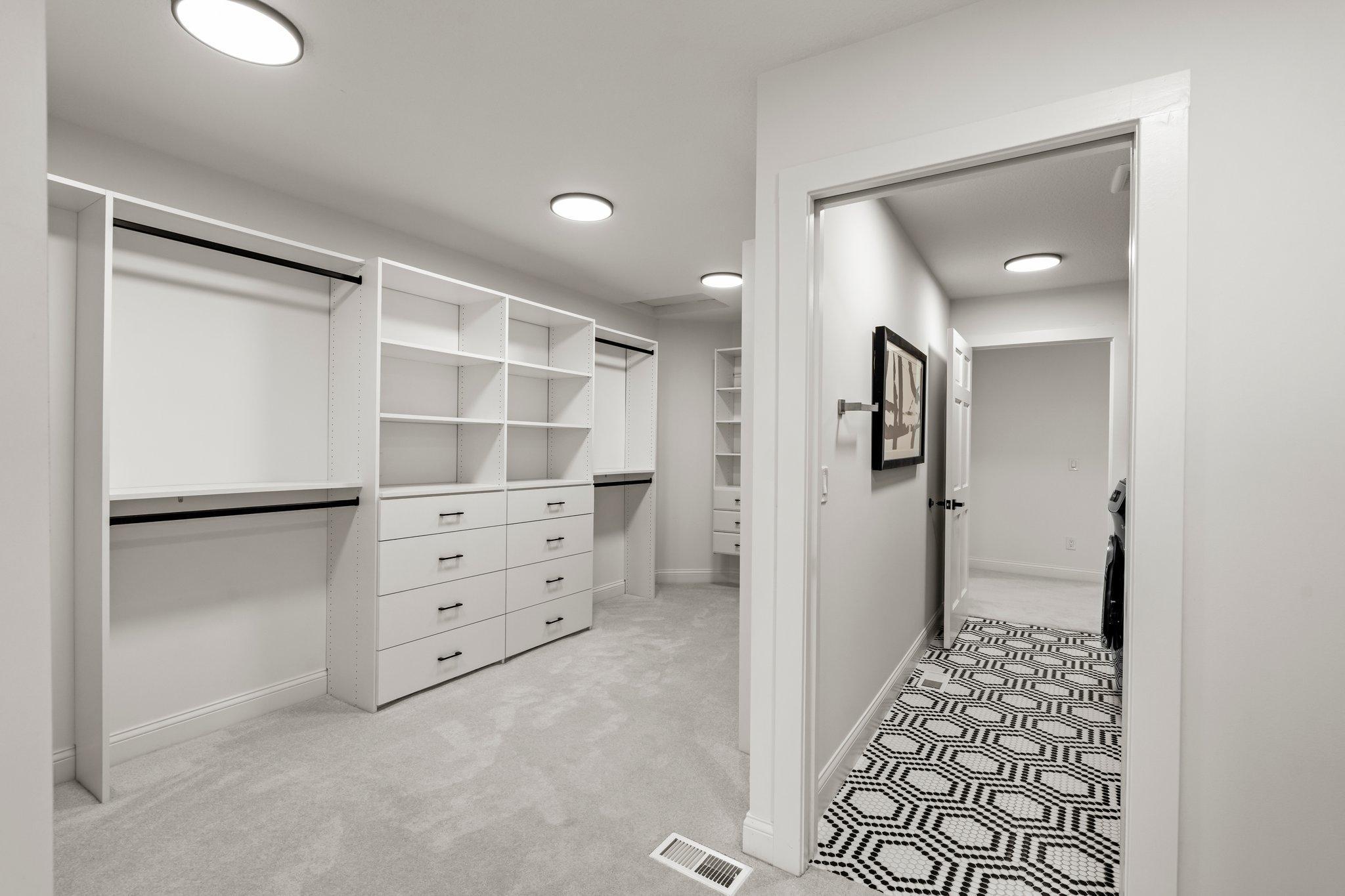 This closet seamlessly passes through to the adjacent laundry room, providing unparalleled convenience and efficiency.