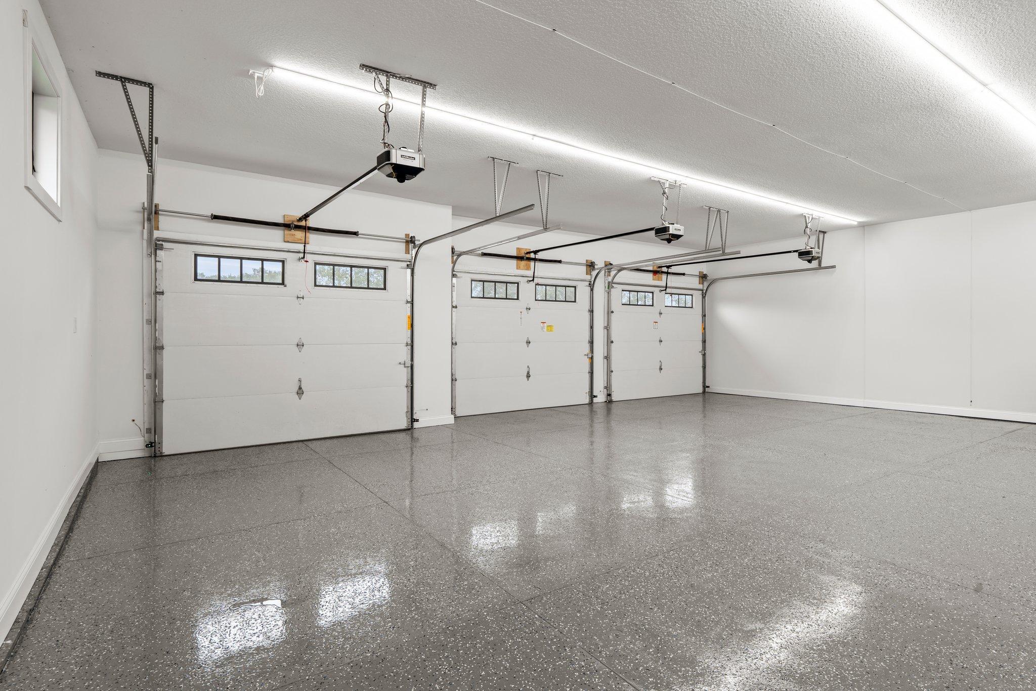 The 3-car garage is a meticulously designed space that is highly functional, making it an exceptional extension of the home. Fully finished, insulated, and heated, and equipped with a rough in for an EV charger with 11-foot ceiling.