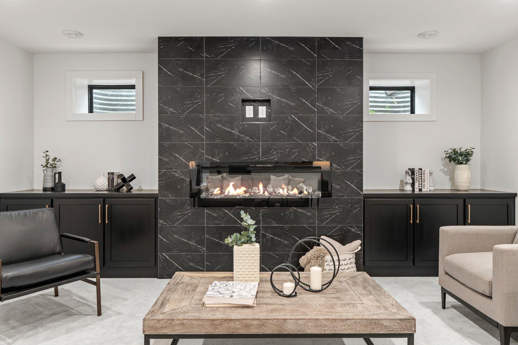 The spacious family room is perfect for gatherings, equipped with extra seating along a sleek quartz countertop. Built-in cabinets provide ample storage, keeping the space organized and clutter-free.