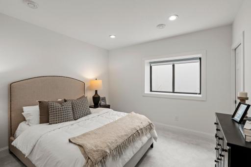 The lower-level bedroom offers comfort and convenience with direct access to a stylish pass-through Â¾ bathroom, perfect for guests or multigenerational living.