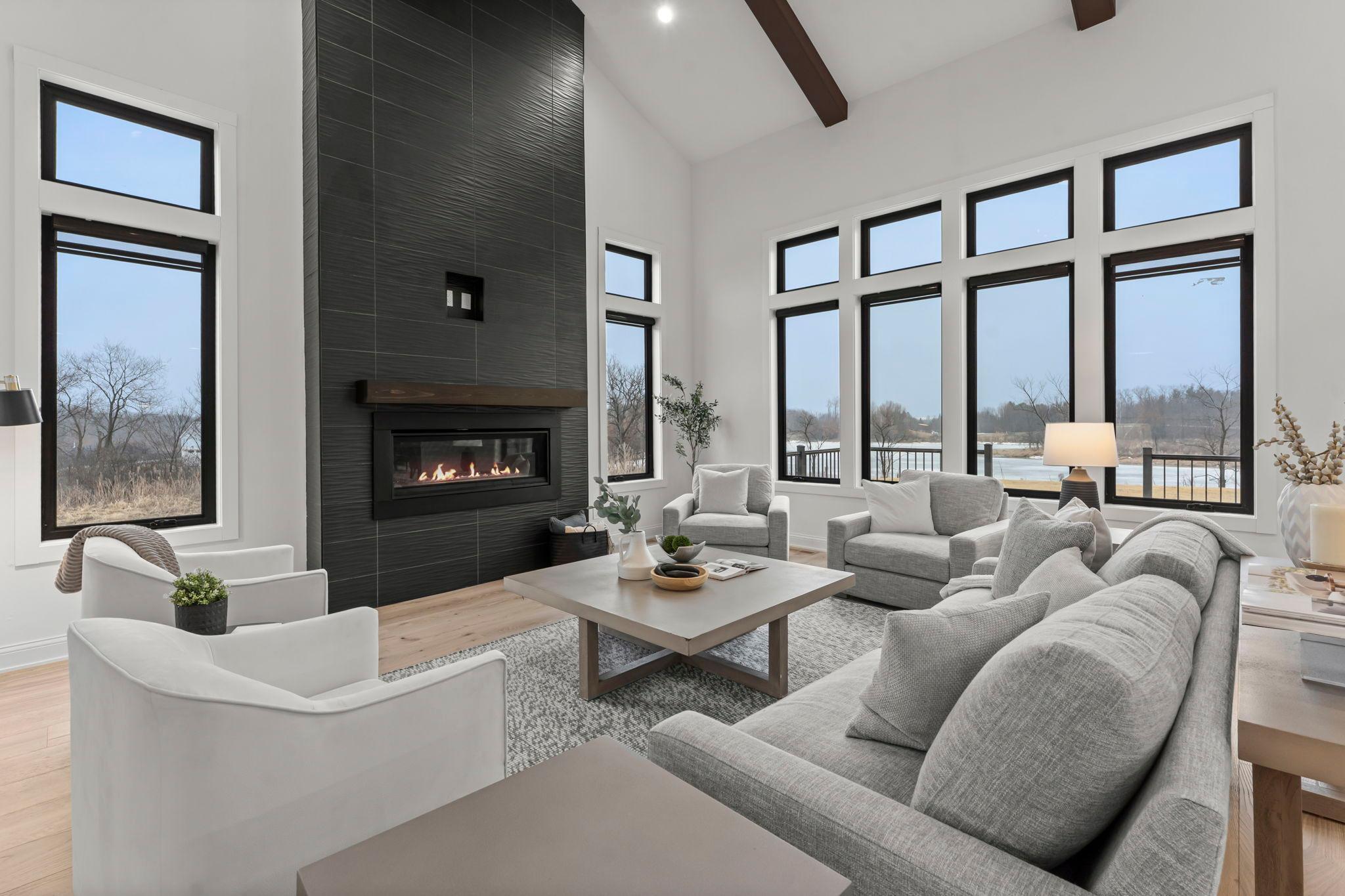 Upon entering, you’ll be welcomed into the stunning great room where 18-foot vaulted ceilings create an impressive sense of space, beautifully accented by wood beams that add warmth and architectural charm.