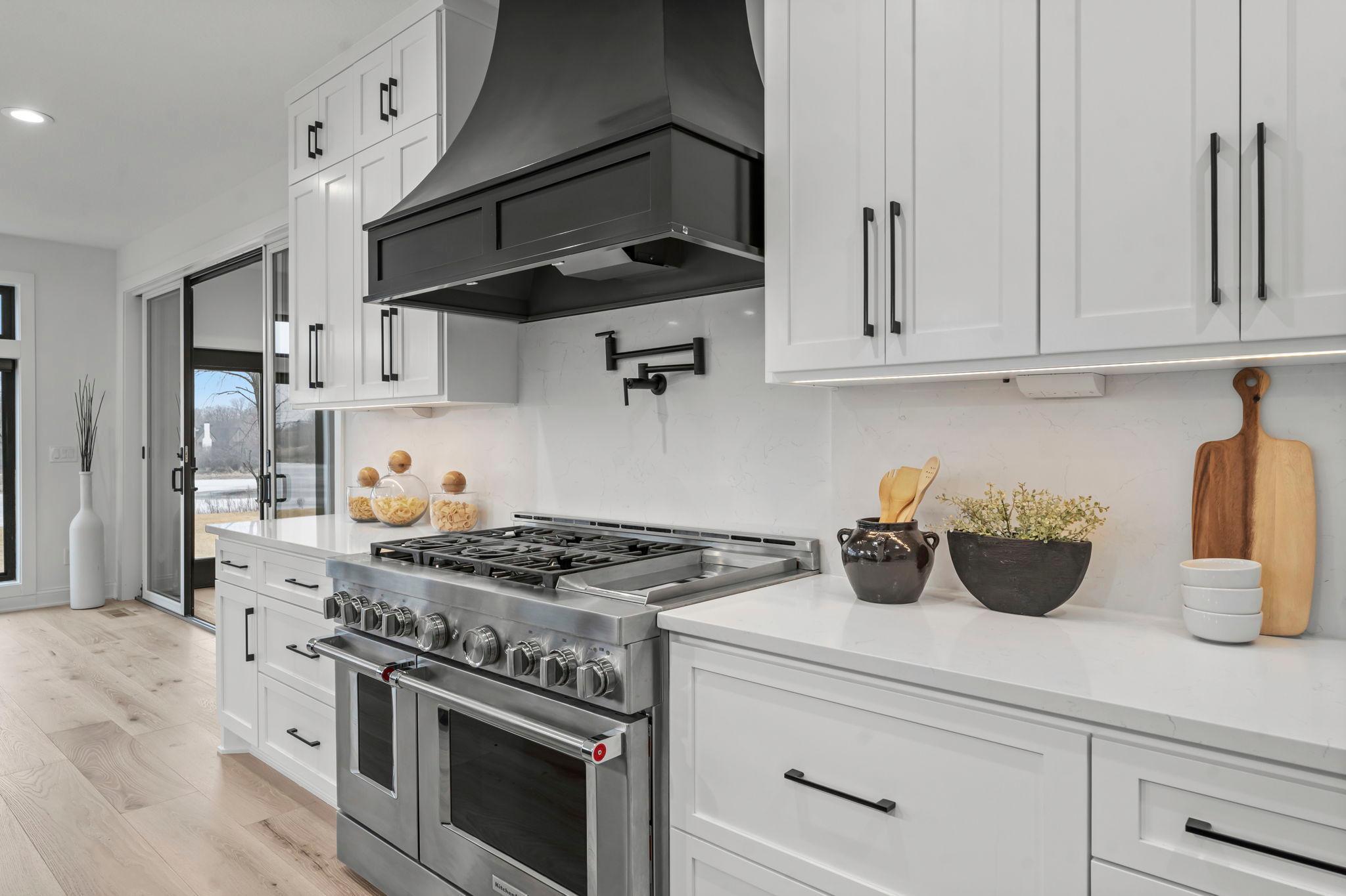 While the remaining appliances are finished in sleek stainless steel including a professional gas range & pot filler, perfect for culinary enthusiasts.