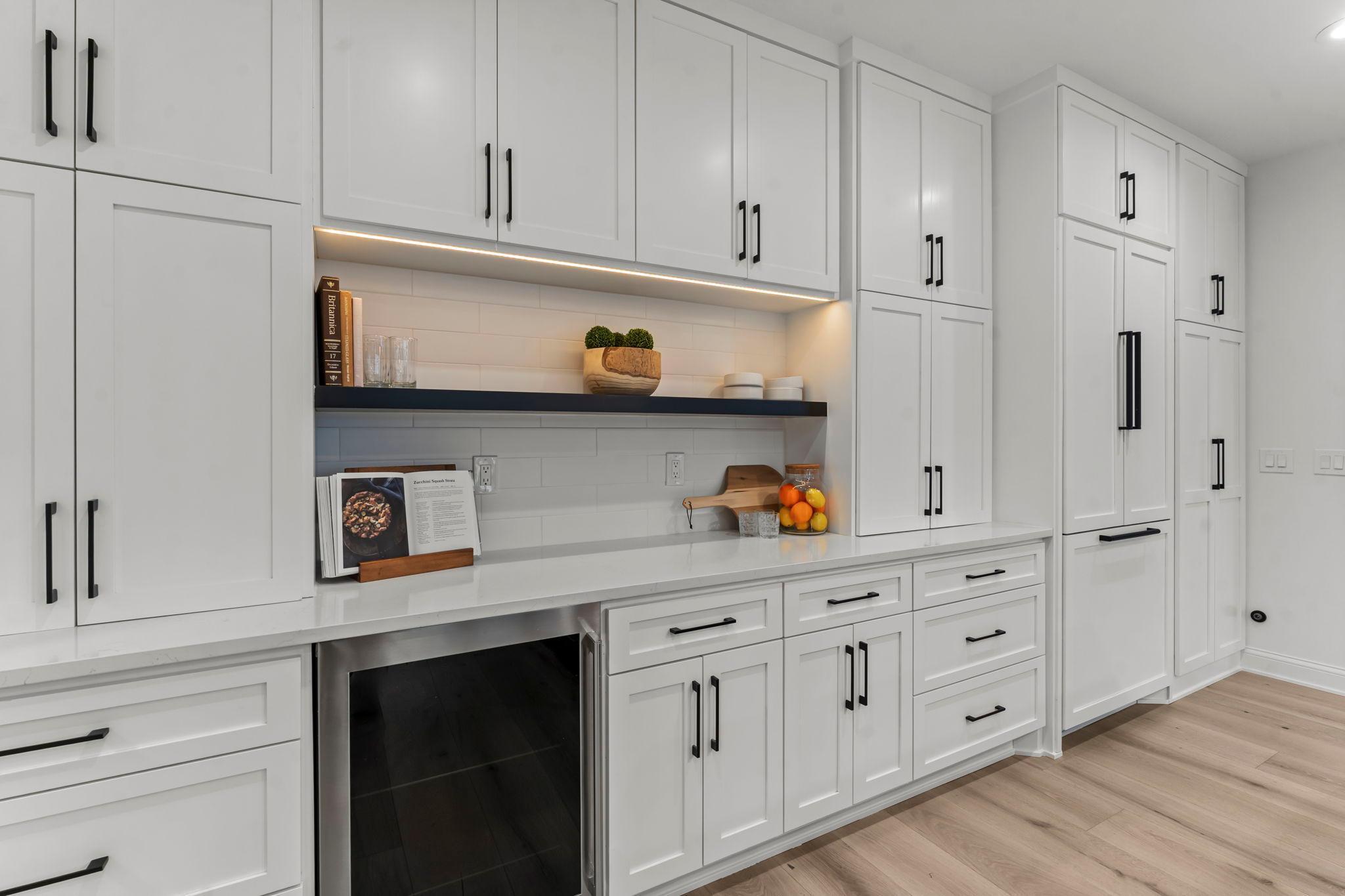 A buffet area with quartz countertops that are appliance depth and additional cabinets offers even more storage and serving space.