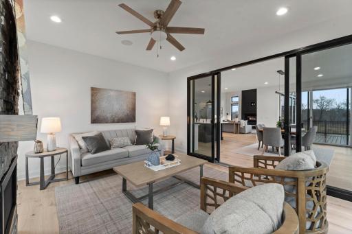 As you enter through the sliding glass door, you are greeted by a warm and inviting atmosphere anchored by a gas fireplace with a charming brick surround.