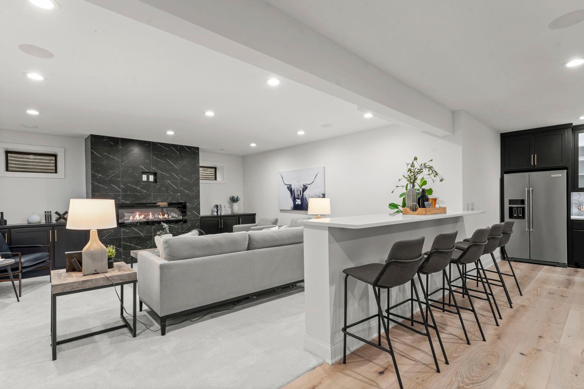 The lower level of this home is a well-appointed space designed for entertaining with nine foot ceilings, featuring a range of high-end finishes and thoughtful details.