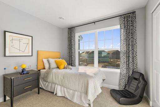 Two secondary bedrooms ideal for guests, office, or hobbies. Model photos. Options and colors may vary.