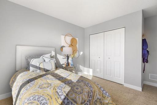 Two secondary bedrooms ideal for guests, office, or hobbies. Model photos. Options and colors may vary.