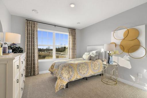 Two secondary bedrooms ideal for guests, office, or hobbies. Model photos. Options and colors may vary.