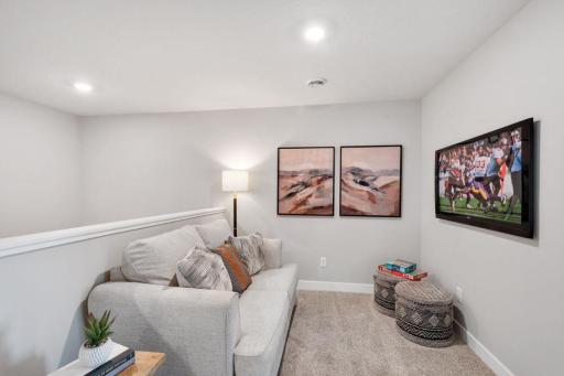 Convenient upper level loft space - perfect for a TV, game area, or working from home. Model photo. Options and colors may vary.
