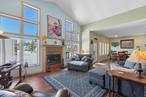 Vaulted living room filled with natural light from a striking wall of windows!