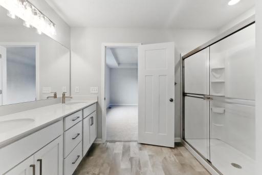 Owner's bathroom en-suite with dual sinks and large shower. Pic for representation purposes. Finishes may vary.