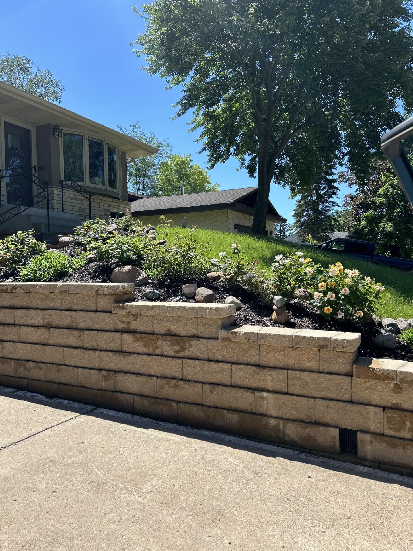 Landscaping by retaining wall in the front