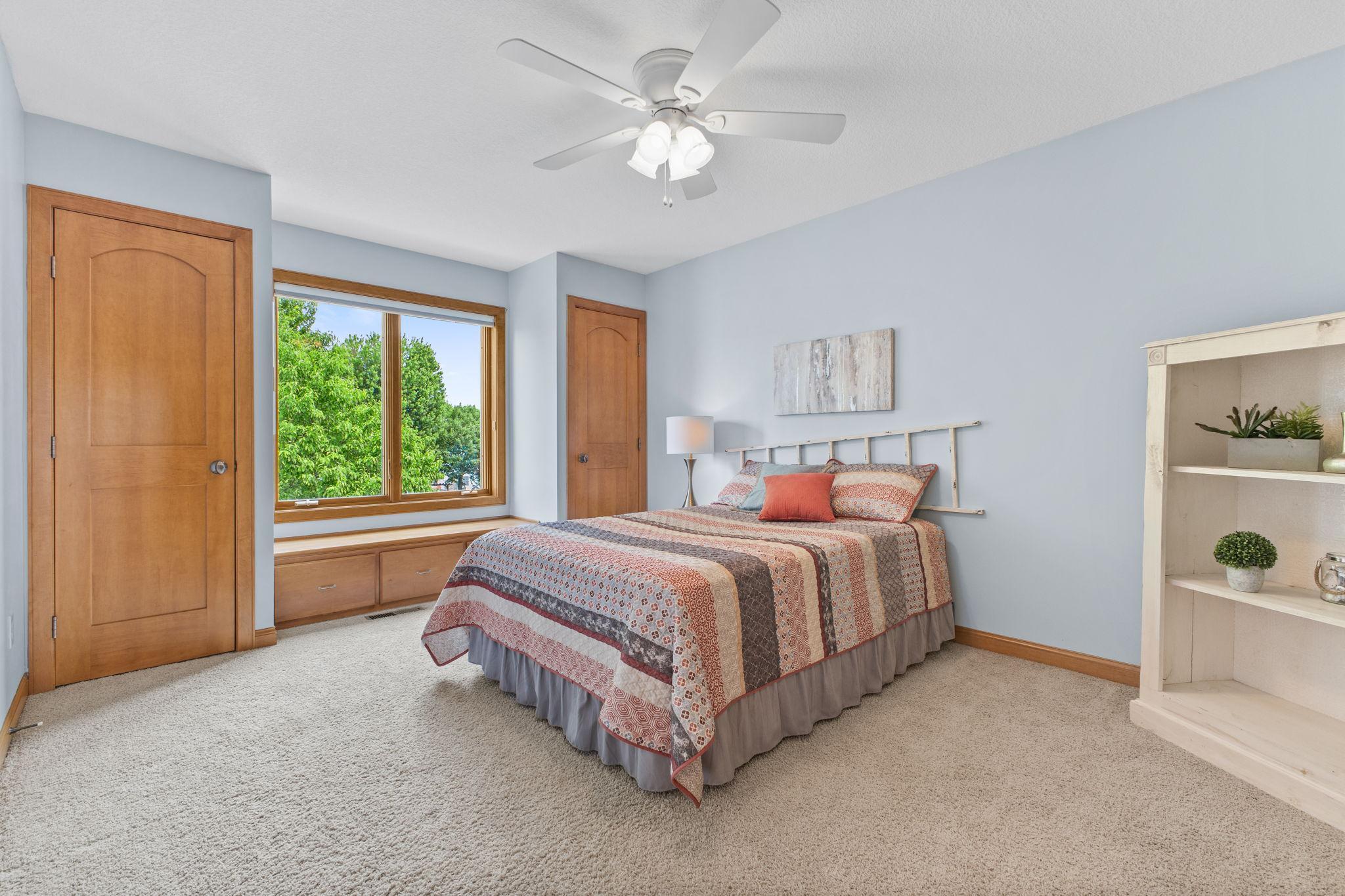 Bedroom three on the upper level with two closets and a charming window bench.