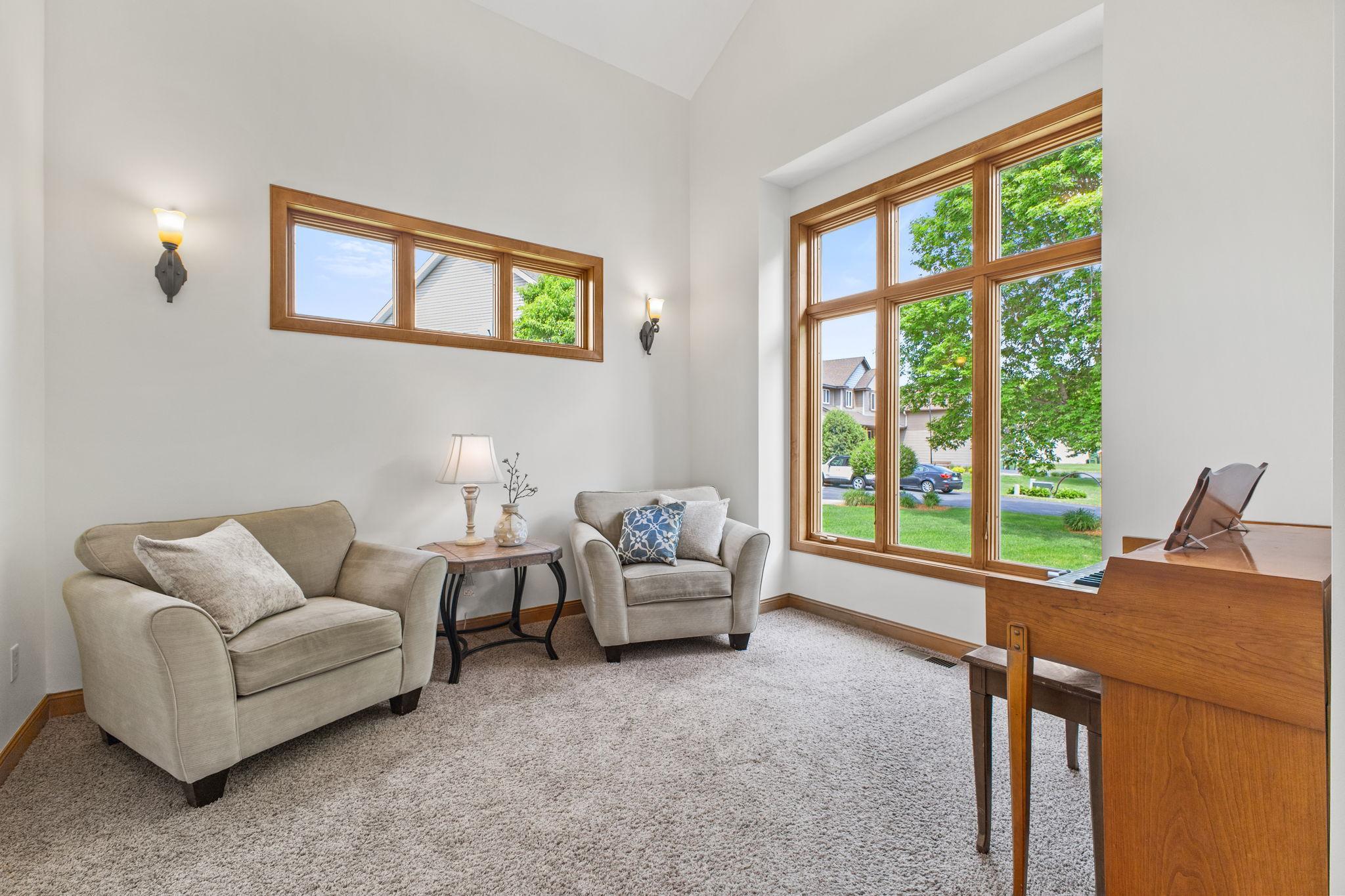 The front sitting room is dramatic with 12' ceilings, wall sconces, neutral flooring and new professional paint.