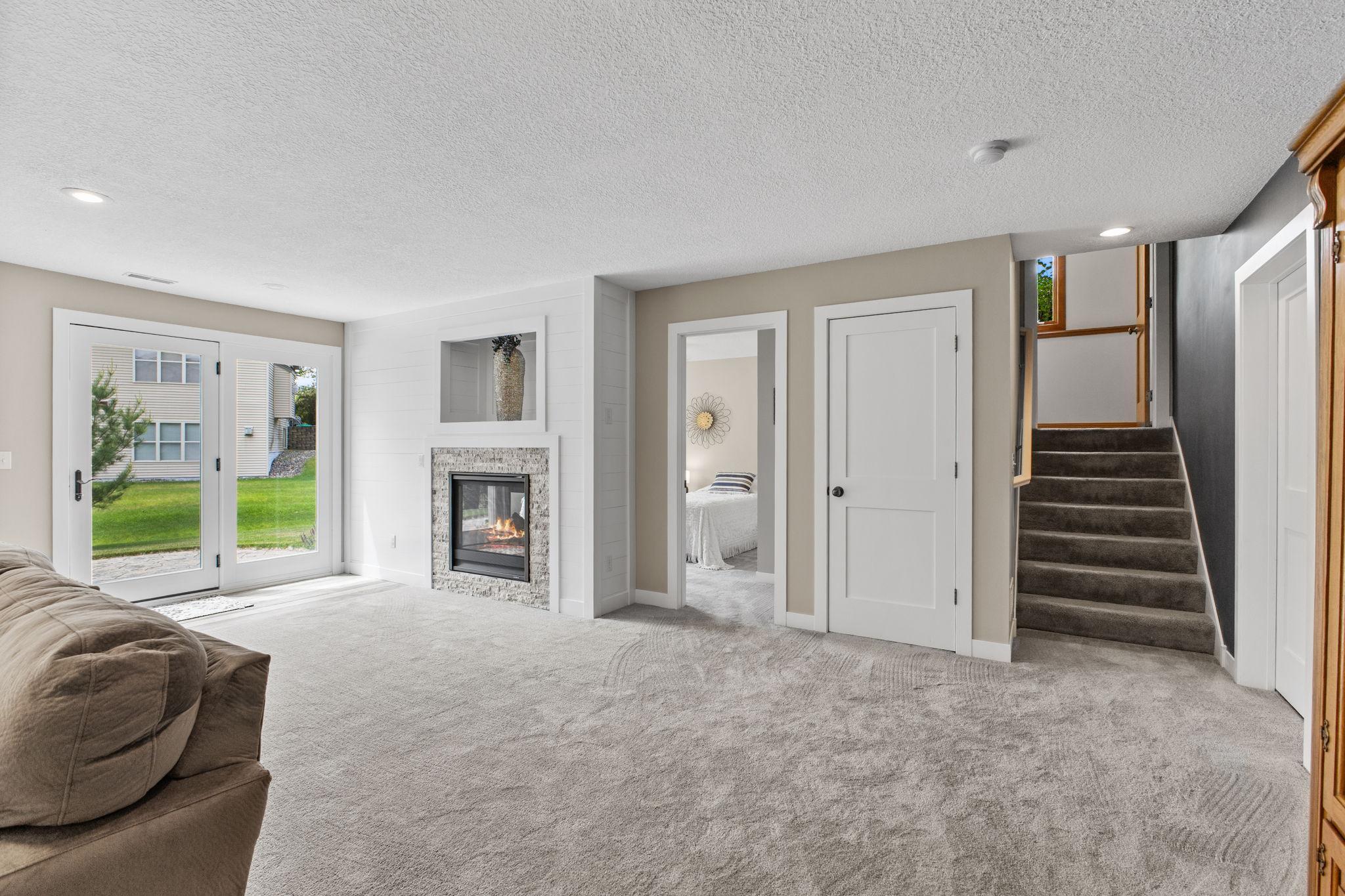 The lower level was recently finished in 2021 to add a fourth bedroom, dual sided fireplace and a huge recreation/living area.