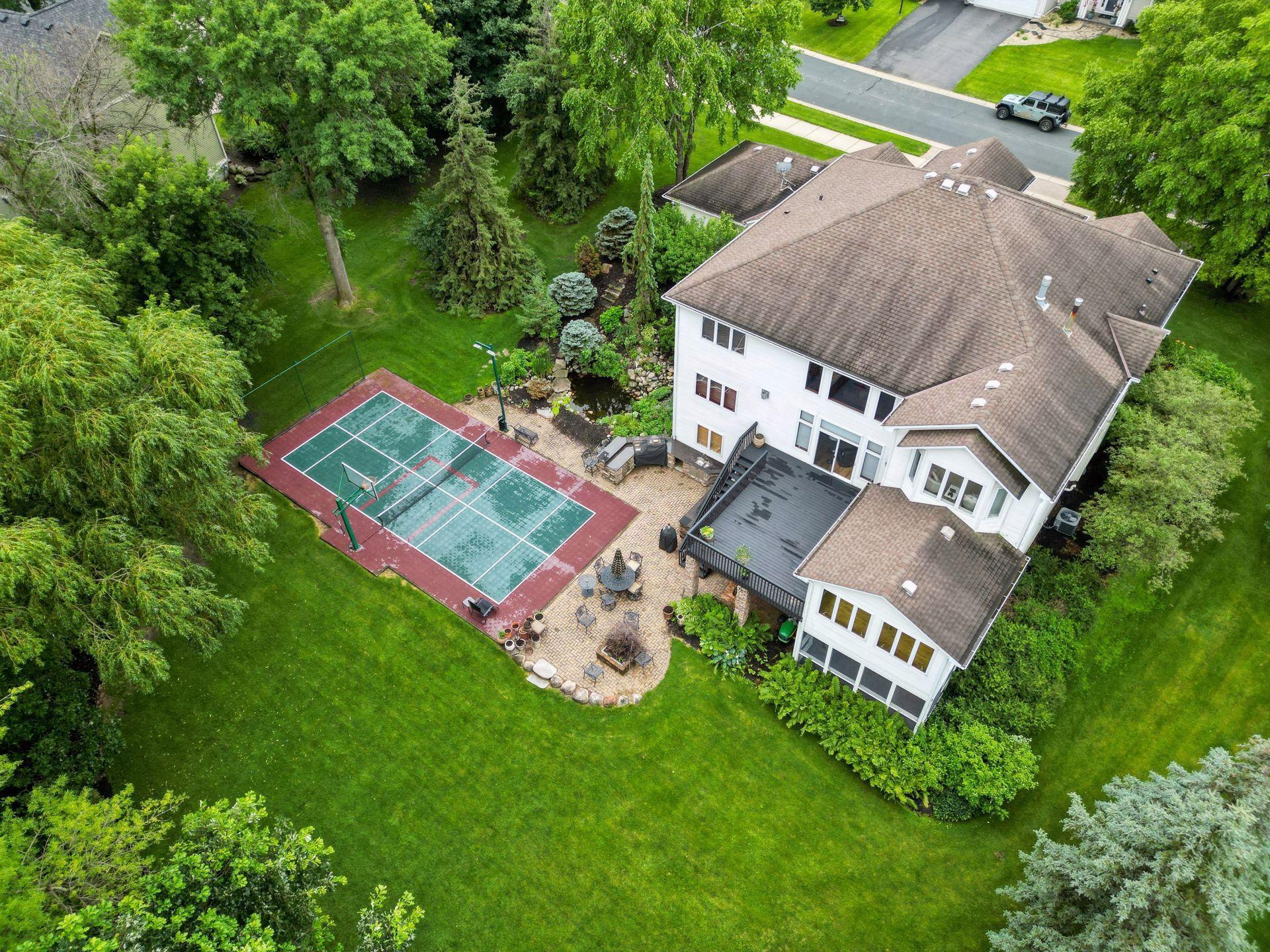 17558 George Moran Drive - Full Pickleball court - 100 feet of lake shore on Mitchell Lake - full stainless outdoor kitchen - Koi pond with a waterfall - private backyard